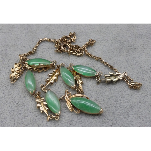 414 - A gold and jade drop necklace, 46cm long, 10.7 grams gross