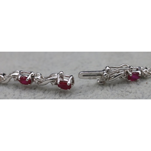 415 - A 14ct white gold bracelet set with small rubies and diamonds, 18.3cm long, 6.2 grams gross