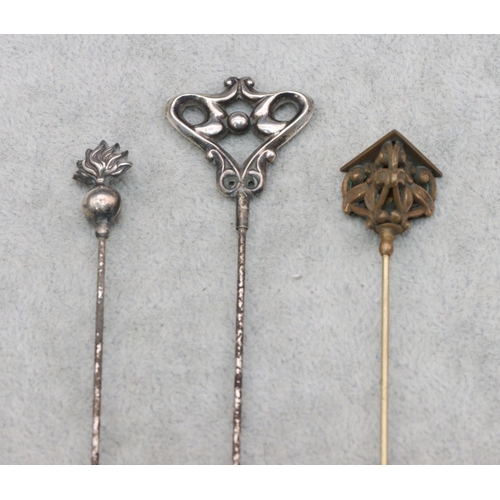 417 - A Birmingham silver hat pin with pierced decoration, a 925 silver hat pain and another gilt metal ha... 