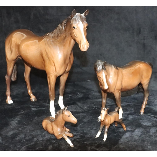 42 - A large Beswick figure of a horse on brown ground (1 hoof chipped), 29cm high and 3 smaller Beswick ... 