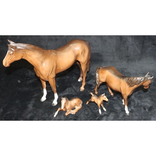 42 - A large Beswick figure of a horse on brown ground (1 hoof chipped), 29cm high and 3 smaller Beswick ... 