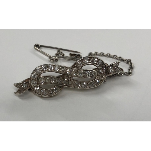 425 - A gold and platinum ribbon brooch inset with diamonds, 3.5cm wide, 4.1 grams gross