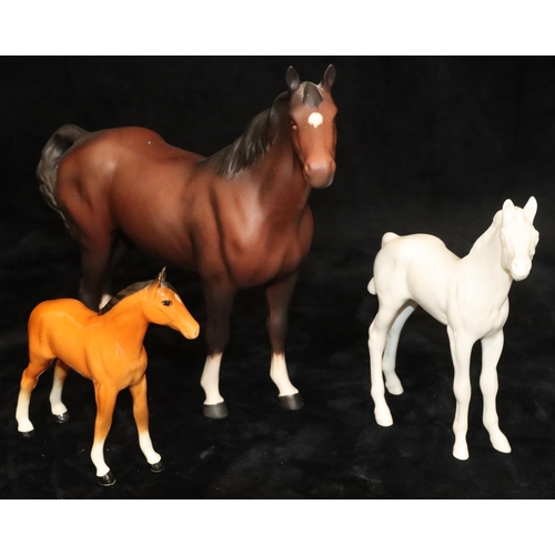 43 - A Beswick mat figure of a horse on brown ground, 21cm high, a Beswick mat figure of a foal on white ... 