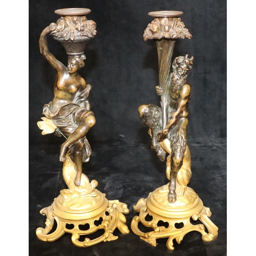 A pair of 19th Century ormolu and bronze candlesticks in the form of a faun seated upon a leopard and a lady seated upon a fish, on splayed pierced bases, 33cm high (slight hole drilled to back of both supports to convert to electricity)