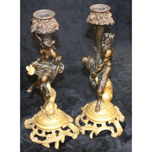 434 - A pair of 19th Century ormolu and bronze candlesticks in the form of a faun seated upon a leopard an... 