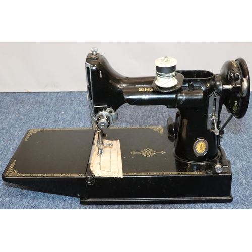 436 - A Singer portable electric sewing machine, no. 221K1, cased with instructions and accessories