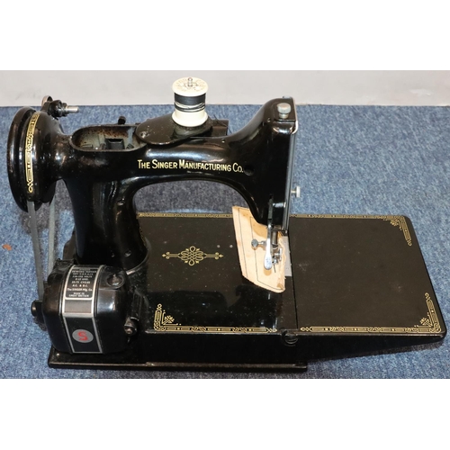 436 - A Singer portable electric sewing machine, no. 221K1, cased with instructions and accessories