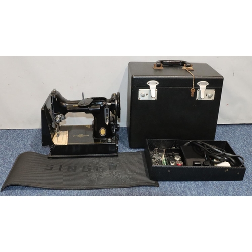 436 - A Singer portable electric sewing machine, no. 221K1, cased with instructions and accessories