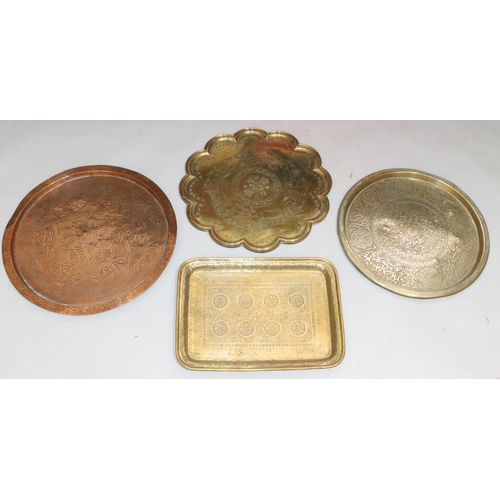 438 - 4 various copper and brass Islamic trays with allover embossed and engraved decoration, including a ... 