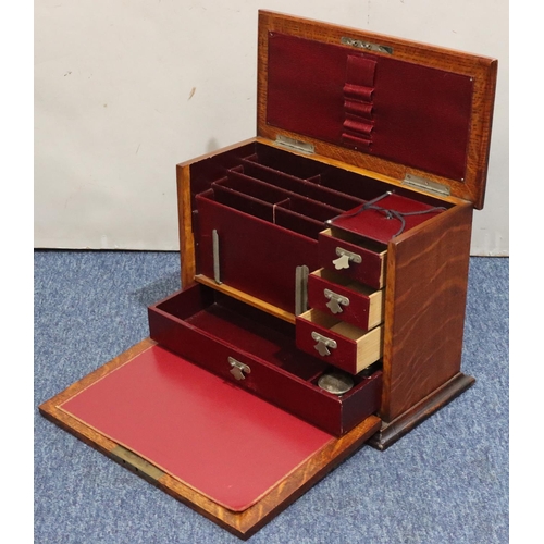 444 - An early 20th Century oak stationery box with hinged top and front enclosing red leather writing slo... 