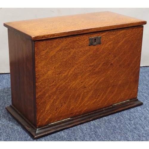 444 - An early 20th Century oak stationery box with hinged top and front enclosing red leather writing slo... 