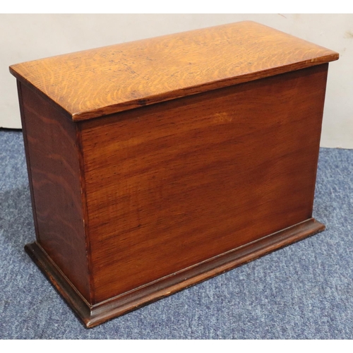 444 - An early 20th Century oak stationery box with hinged top and front enclosing red leather writing slo... 