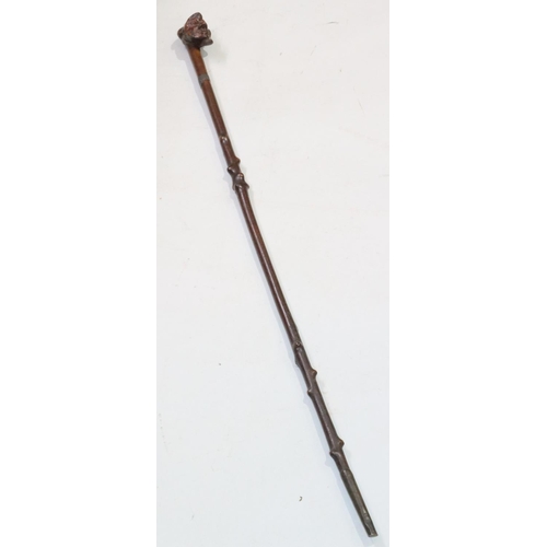 447 - A carved walking stick with figurehead motif, 86.5cm long overall