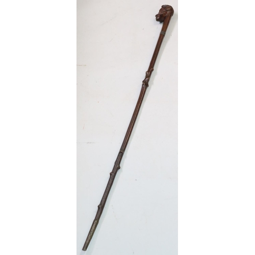 447 - A carved walking stick with figurehead motif, 86.5cm long overall