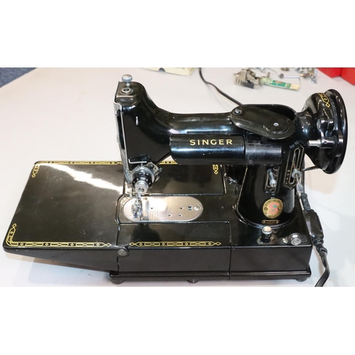 452 - A Singer 22K electric sewing machine, cased, with various accessories, instruction manual etc. (bar ... 