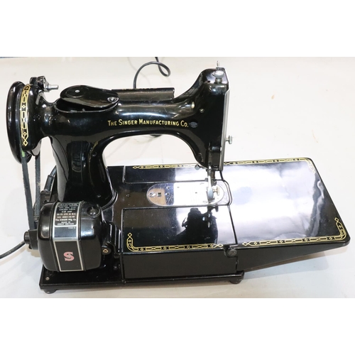 452 - A Singer 22K electric sewing machine, cased, with various accessories, instruction manual etc. (bar ... 