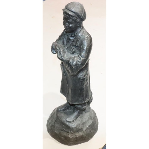 457 - A lead figure of a standing young boy on round base, 42cm high