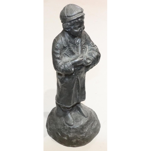 457 - A lead figure of a standing young boy on round base, 42cm high