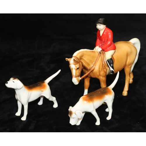 46 - A Beswick figure of a child upon a chestnut horse, 14cm high and 2 Beswick figures of hounds