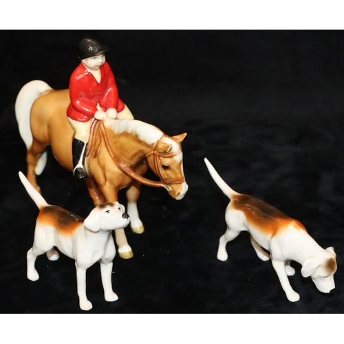 46 - A Beswick figure of a child upon a chestnut horse, 14cm high and 2 Beswick figures of hounds