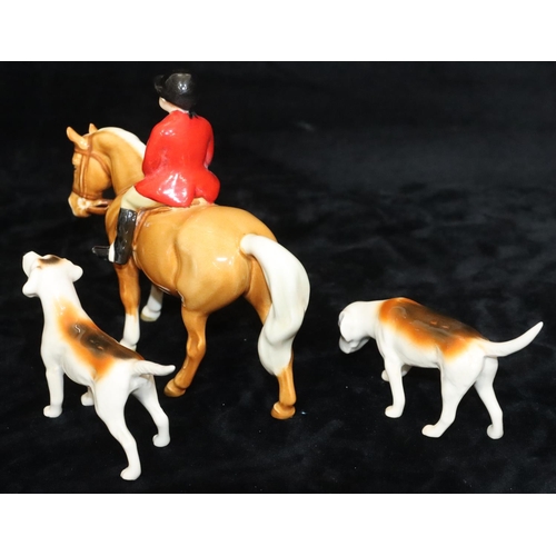 46 - A Beswick figure of a child upon a chestnut horse, 14cm high and 2 Beswick figures of hounds