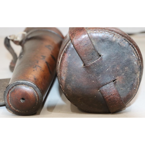 471 - A leather bound travelling bottle with cover and strap, bottle 32cm high and a glass circular taperi... 