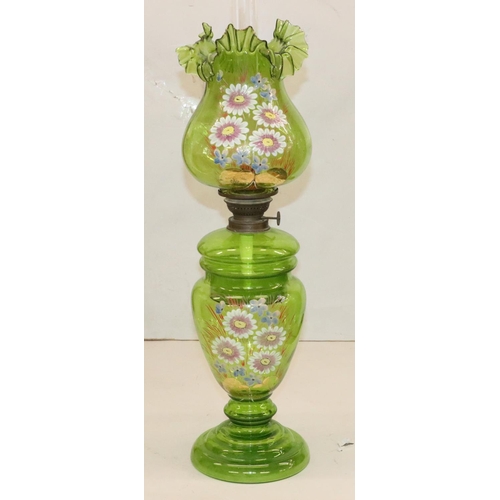 484 - A green glass oil lamp on round bulbous base with separate top, mounted with chimney and round bulbo... 