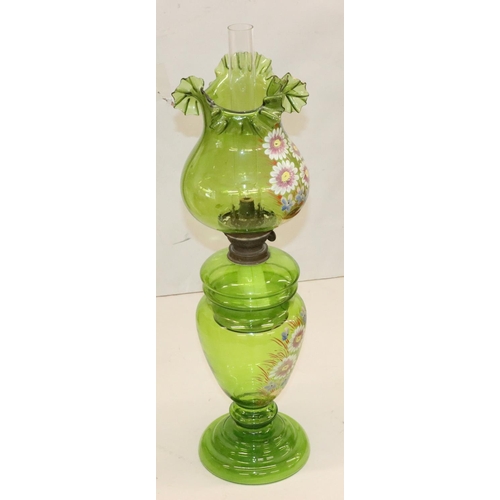 484 - A green glass oil lamp on round bulbous base with separate top, mounted with chimney and round bulbo... 