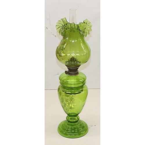 484 - A green glass oil lamp on round bulbous base with separate top, mounted with chimney and round bulbo... 