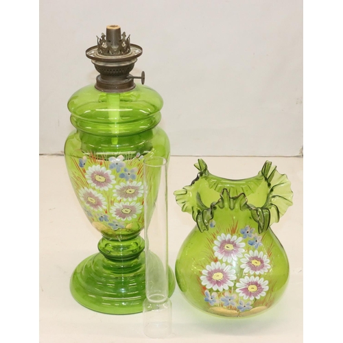 484 - A green glass oil lamp on round bulbous base with separate top, mounted with chimney and round bulbo... 