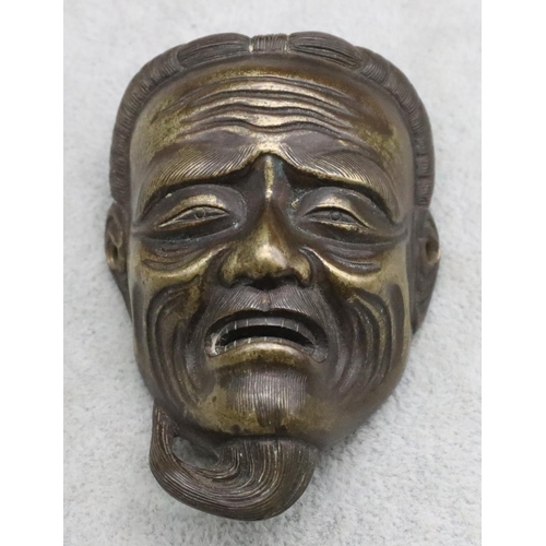 486 - A small Oriental bronze mask of a gentleman 7.8cm high