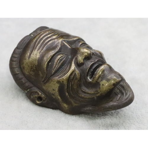 486 - A small Oriental bronze mask of a gentleman 7.8cm high