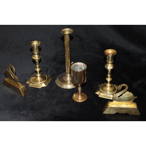 489 - A pair of early brass candlesticks on turned stems with square scallop shaped bases, 18cm high and a... 