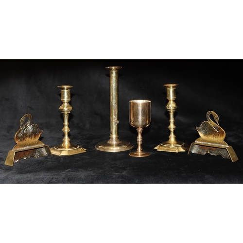 489 - A pair of early brass candlesticks on turned stems with square scallop shaped bases, 18cm high and a... 