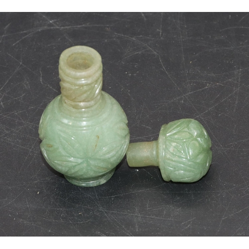 513 - An Oriental jade small round bulbous thin necked scent bottle with stopper and allover carved floral... 