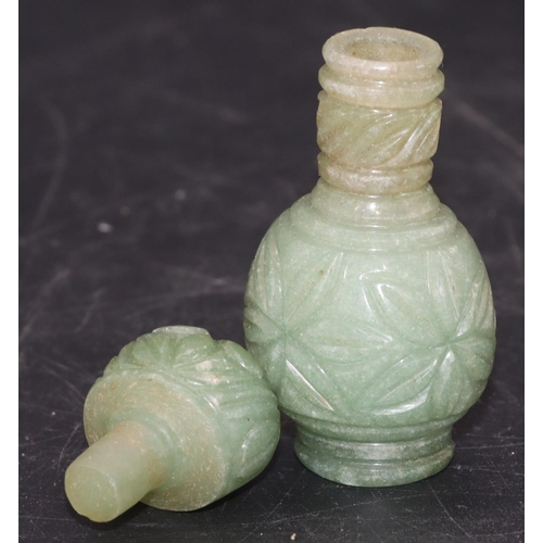 513 - An Oriental jade small round bulbous thin necked scent bottle with stopper and allover carved floral... 