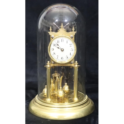 529 - A gilt metal Anniversary clock with circular white enamel dial and Arabic numerals, under glass dome... 