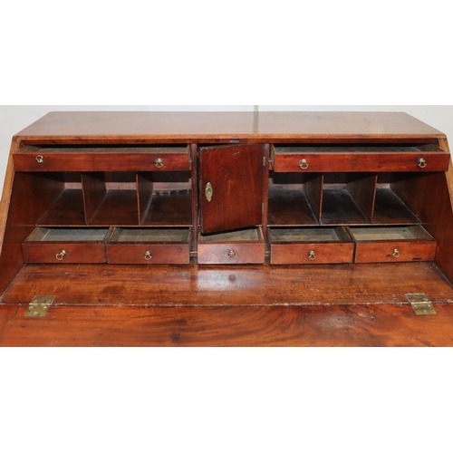 542 - A George III figured mahogany bureau with fall front enclosing fitted interior, panel door, pigeonho... 