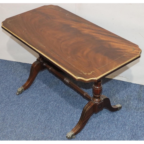 546 - A mahogany rectangular shaped coffee table with brass inlaid decoration, turned end supports with ce... 