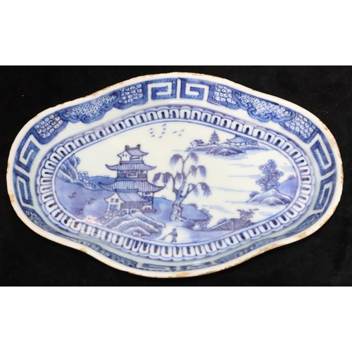 55 - An 18th Century Chinese blue and white rectangular scallop shaped dish with river landscape, buildin... 