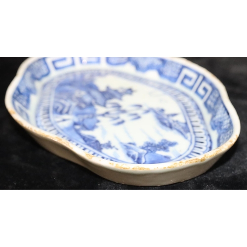 55 - An 18th Century Chinese blue and white rectangular scallop shaped dish with river landscape, buildin... 