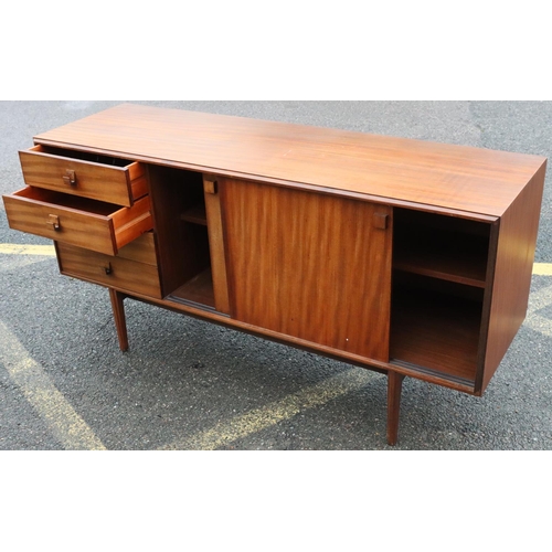 562 - A Danish mid Century sideboard with 2 sliding doors and 4 drawers to one end, tapering fluted legs, ... 