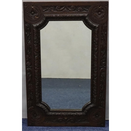 563 - A Victorian carved oak wall mirror having allover leaf and scroll decoration, 68cm x 48cm (converted... 