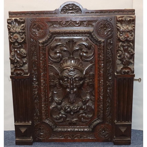 564 - A Victorian carved oak hanging cabinet with single door with carved mask head, fruit, leaf, scroll a... 