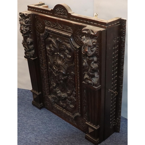 564 - A Victorian carved oak hanging cabinet with single door with carved mask head, fruit, leaf, scroll a... 