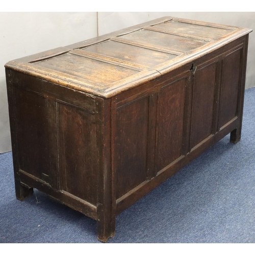 570 - An 18th Century oak coffer with 4 panelled front, part hinged lid (original hinges but no lock), on ... 