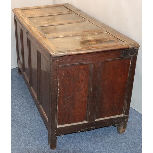 570 - An 18th Century oak coffer with 4 panelled front, part hinged lid (original hinges but no lock), on ... 