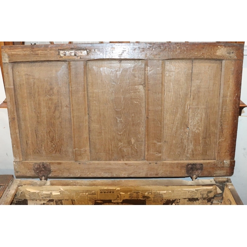 570 - An 18th Century oak coffer with 4 panelled front, part hinged lid (original hinges but no lock), on ... 