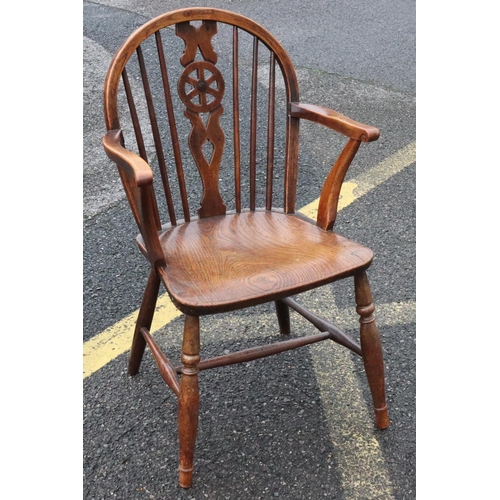 571 - A 19th Century yew and elm wheel and stick back armchair with solid seat on round turned legs and st... 