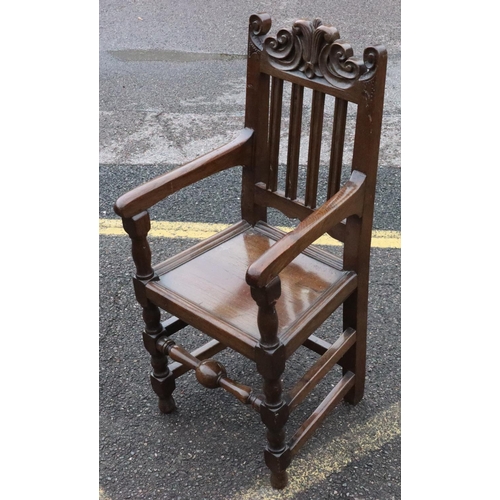 572 - An 18th Century oak narrow armchair with fluted stick back with carved scroll decoration, solid seat... 